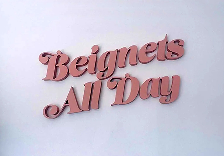 Beignets All Day foam logo cutout in pink for interior branding