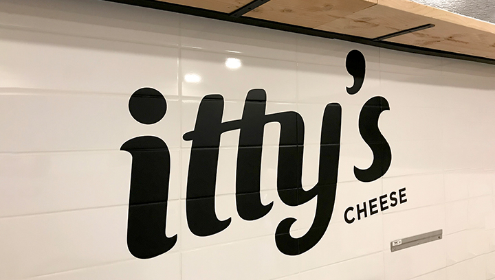 itty's cheese vinyl wall lettering in black displaying the brand name made of opaque vinyl
