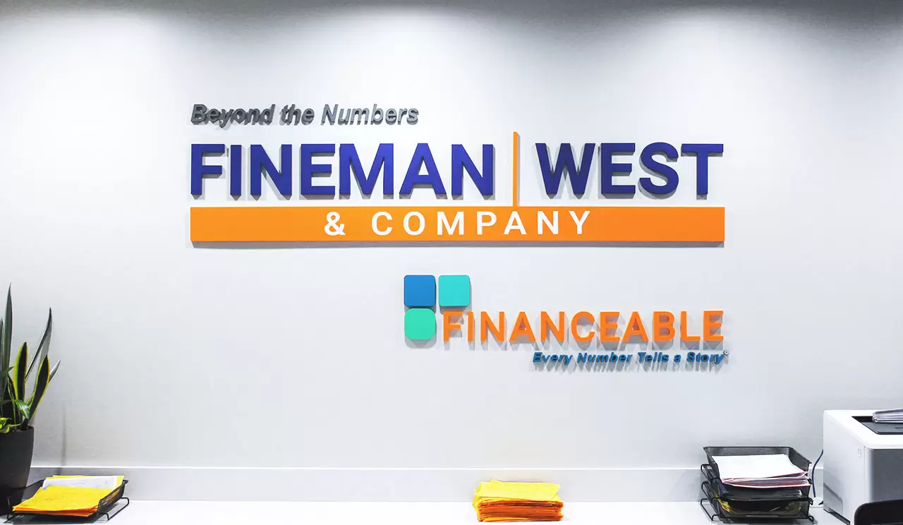 Vivid office lobby signs Fineman West and Company featuring company logo
