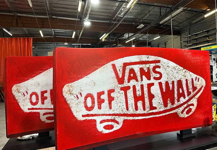 Creative Drinking Agency foam board signs in red displaying the text Vans Off the Wall