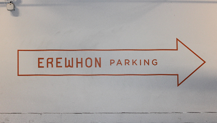 Erewhon informational wall decal displaying parking directional arrow made of opaque vinyl