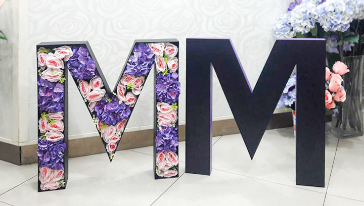 flower-filled event foam boards with free-standing letters made of gator board