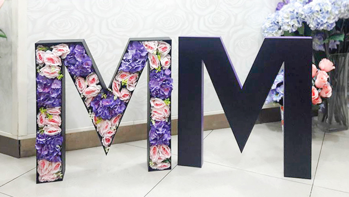 Flower-filled foam logo cutout in a free-standing style made of gator board