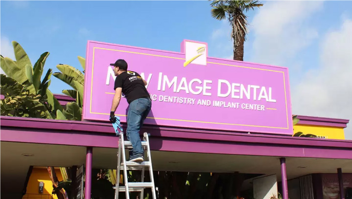 New Image Dental signage repair of a pink display made of aluminum and acrylic for branding