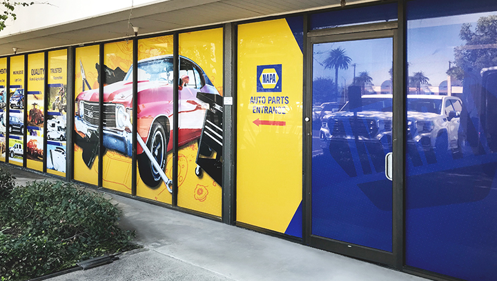 Napa Auto Parts full window wraps in yellow made of perforated vinyl for storefront branding