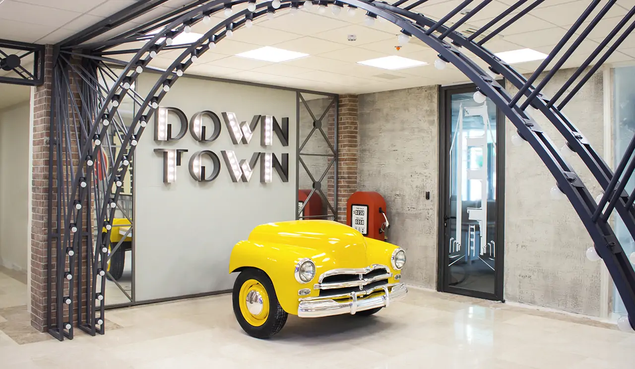 Creative office lobby signs for Down Town featuring a custom retro car design