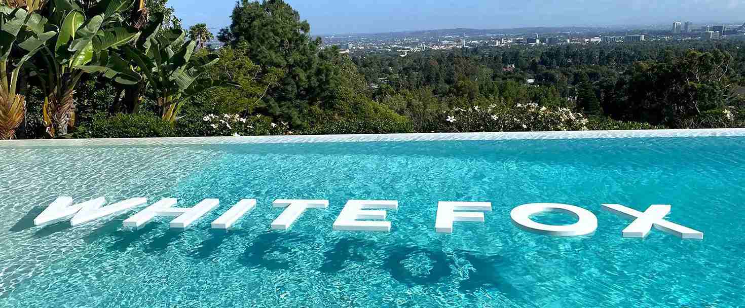 White Fox custom foam board cut-outs with white brand name letters for swimming pool branding