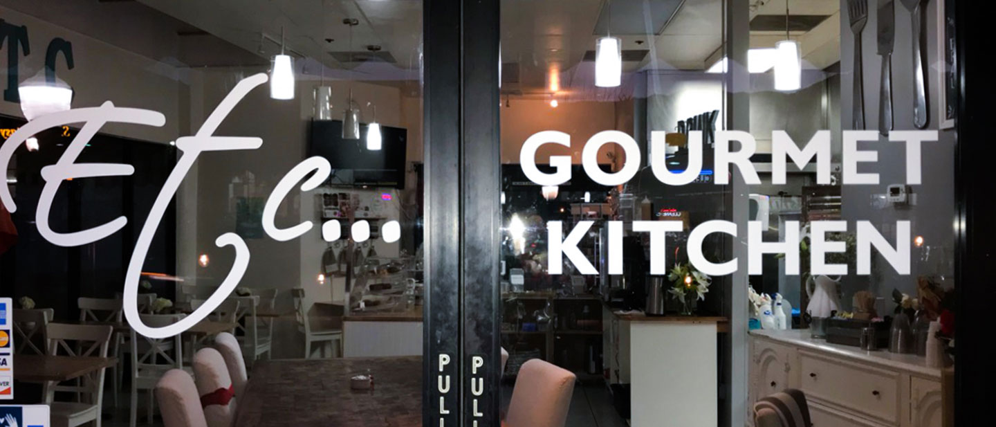 Gourmet Kitchen vinyl lettering of the restaurant name made of opaque vinyl for branding