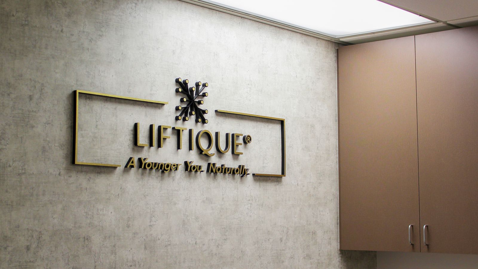 Liftique Clinic office lobby logo sign and slogan made of aluminum and acrylic for branding