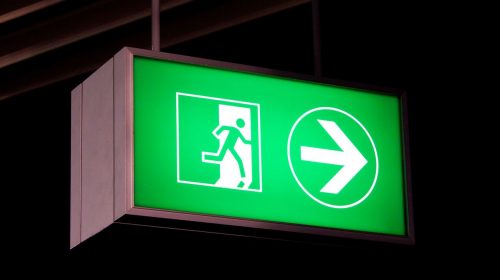 directional LED light box in green directing to the exit made of aluminum and acrylic