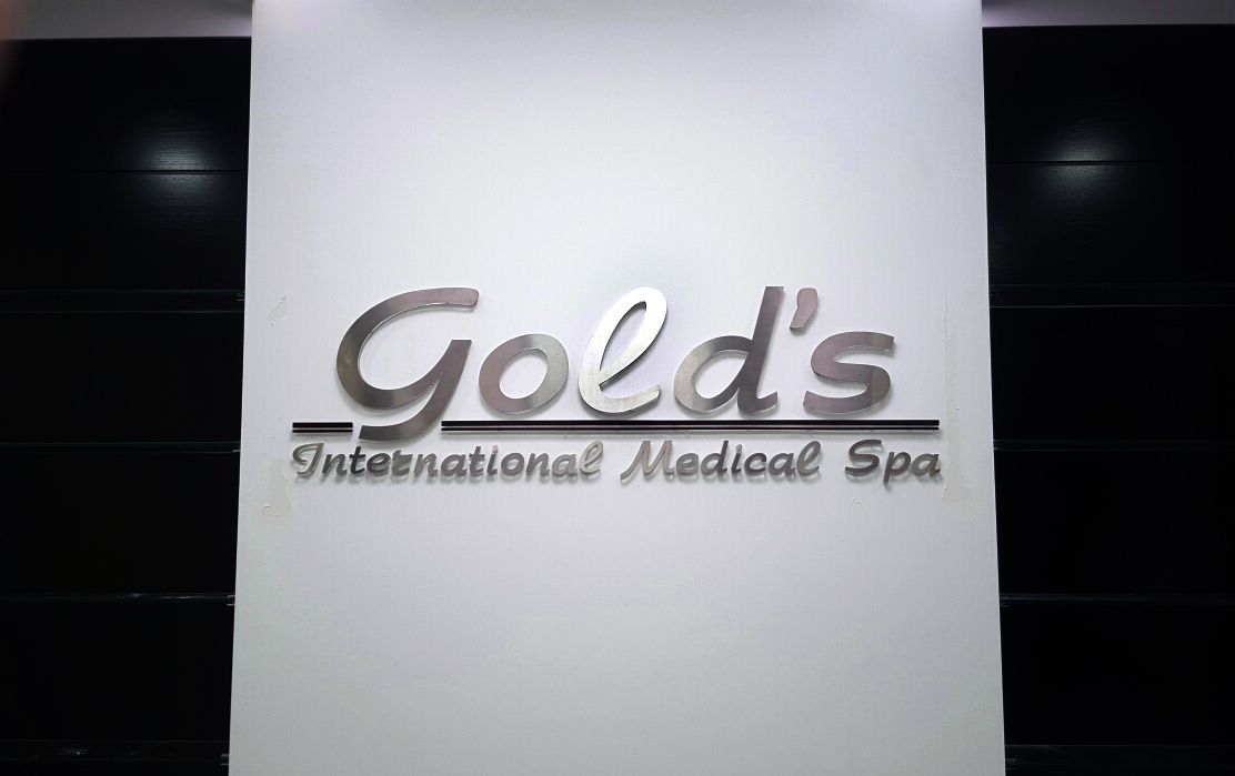 Gold's International Medical Spa indoor business sign made of acrylic and opaque vinyl
