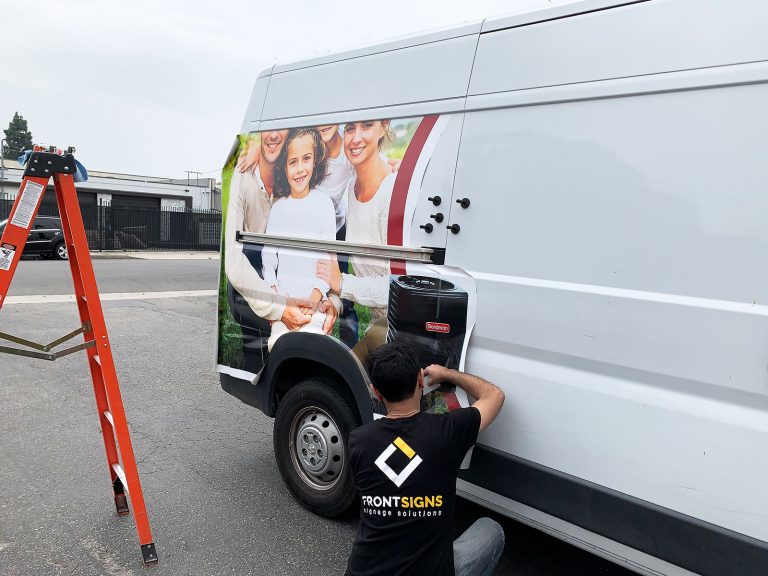 Vehicle wrap installation process with a squeegee Front Signs