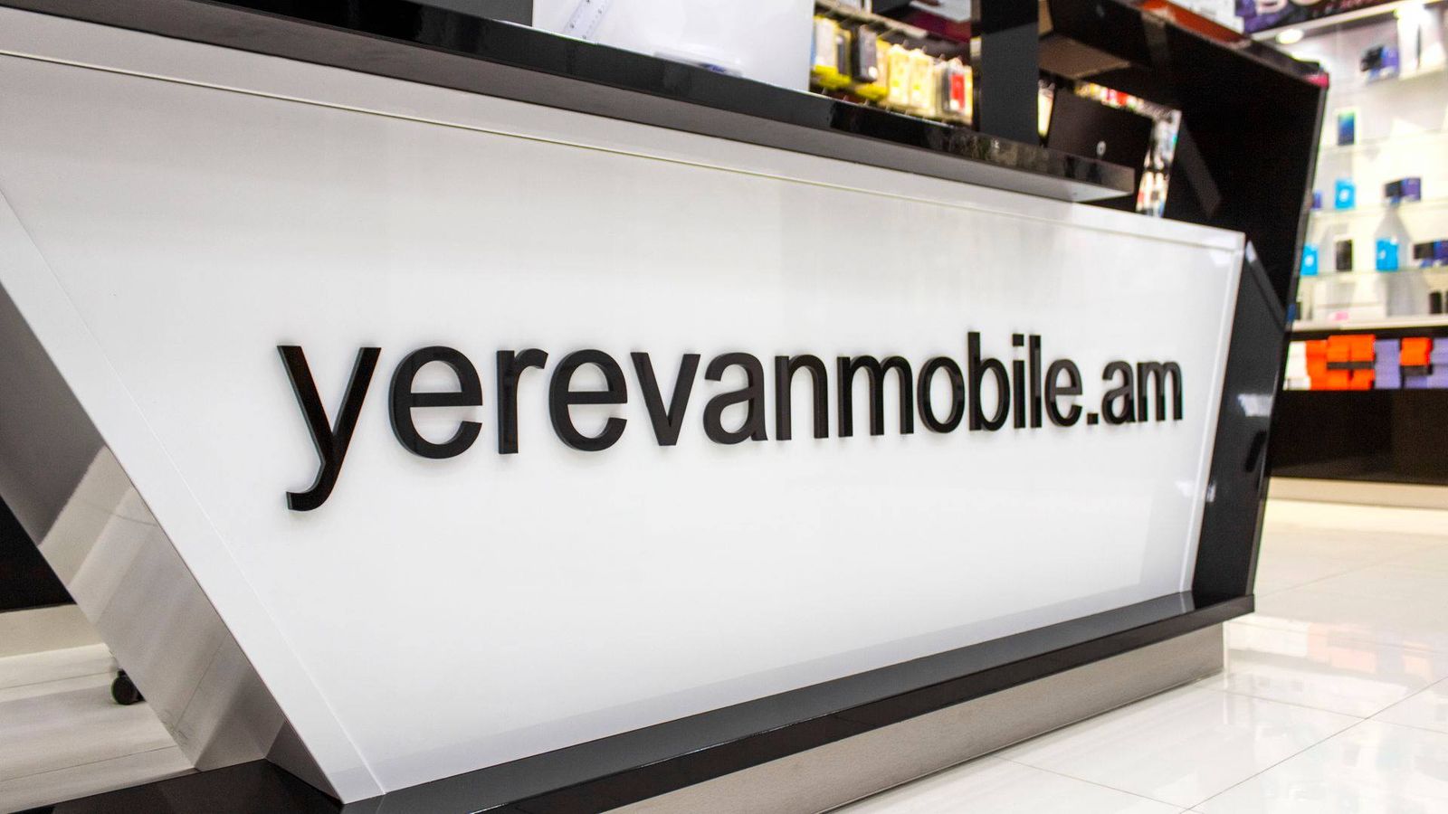 Yerevanmobile 3d acrylic letters in black fixed to the reception desk for office branding