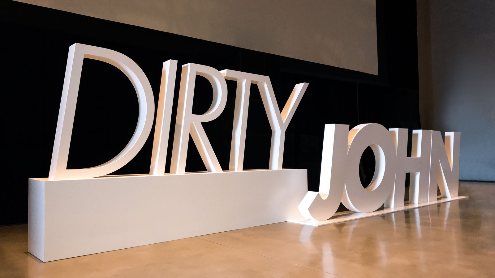 big 3d plastic letters stand sign in white displaying the words Dirty John made of PVC