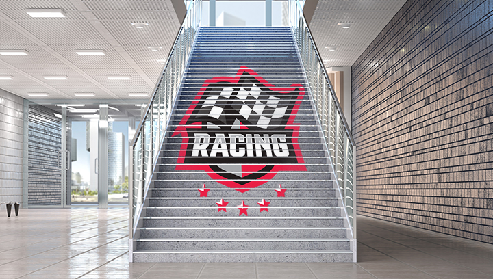 Racing event sign displaying the event name and logo graphics on staircase risers