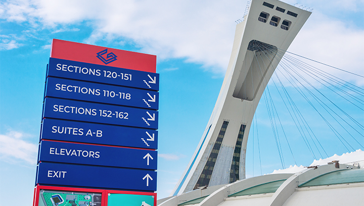 huge stadium wayfinding signage in blue and red displayed outdoors