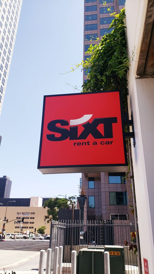 Sixt double-sided cabinet sign in red with the company logo made of aluminum and acrylic