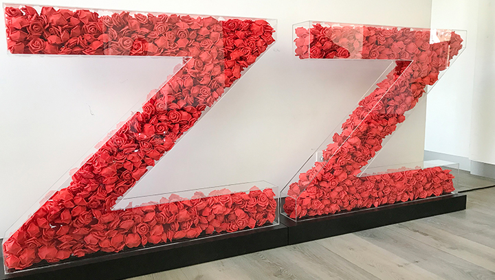 Custom event signs for branding made of large letters filled with artificial red roses