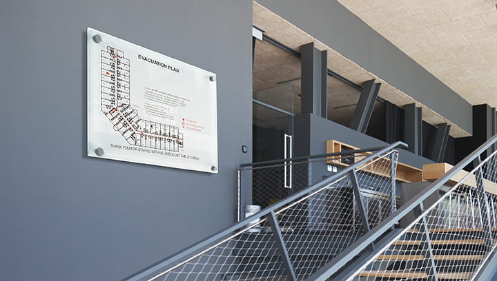 informational arena signage displaying evacuation plan fixed to the wall