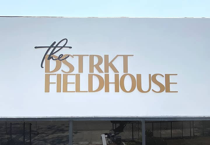 The DSTRKT Fieldhouse stadium branding with a company name display made of acrylic