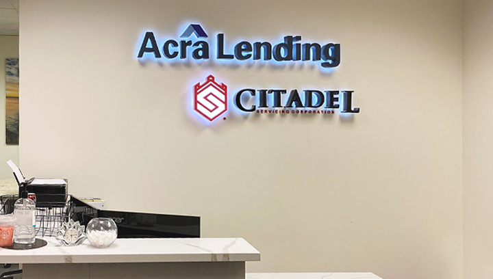 Acra Lending light up bank sign displaying the brand name and logo made of aluminum