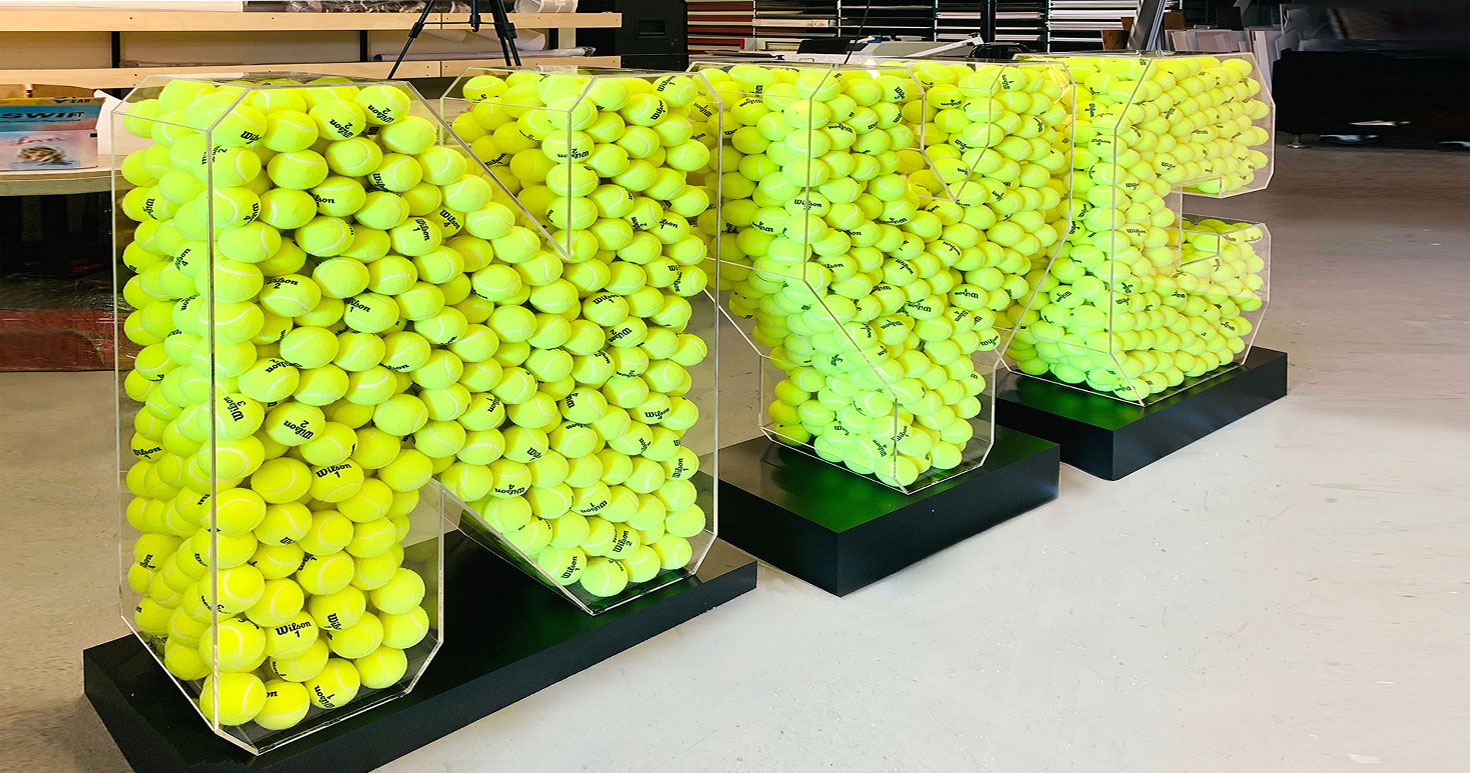 3D NYC acrylic letters with green tennis balls