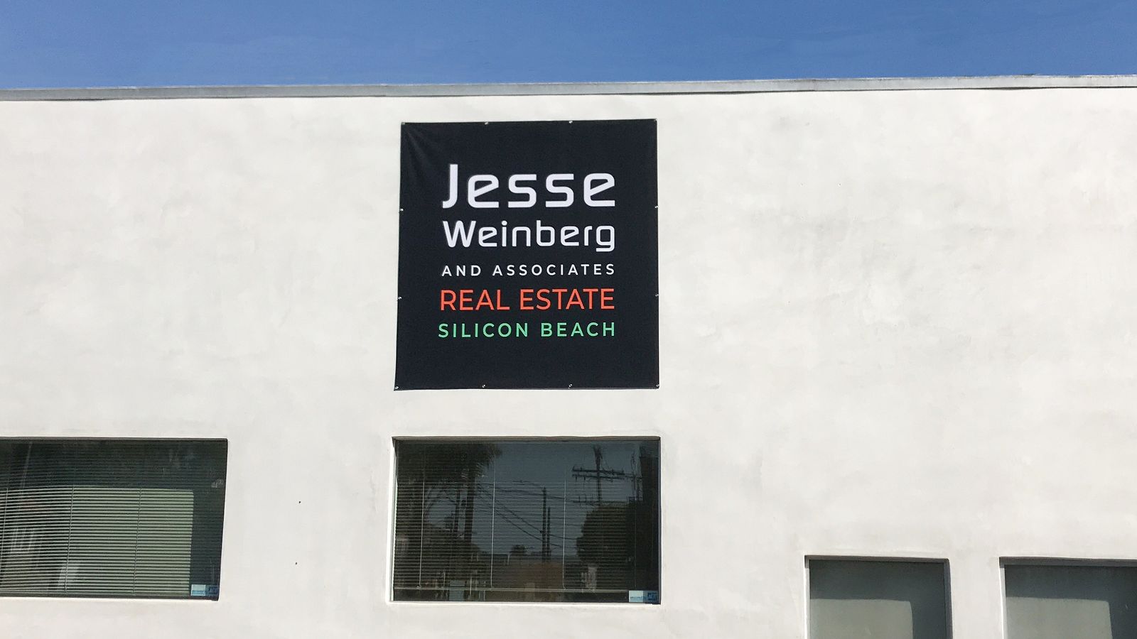 Exterior wall-mounted banner