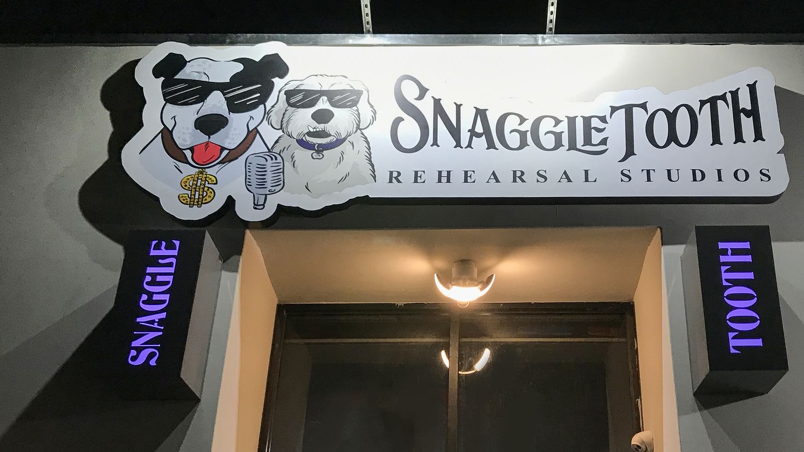 Snaggle Tooth Rehearsal Studios outdoor light boxes in black made of aluminum and acrylic