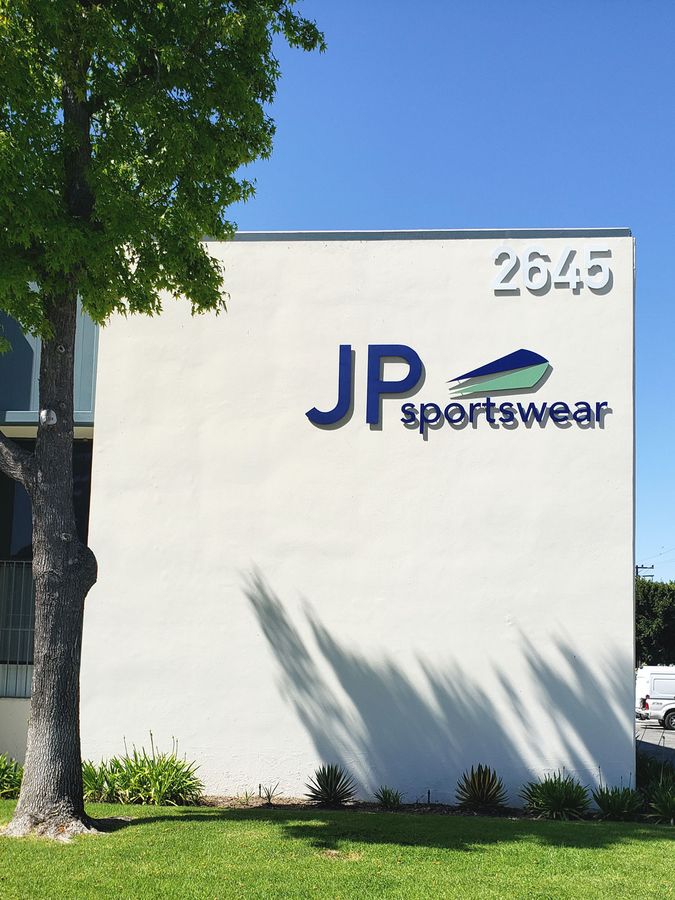 JP Sportswear 3d metal sign with the company name, logo, and address number made of aluminum