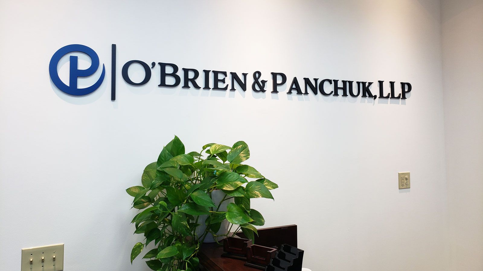 O'Brien & Panchuk, LLP 3d office sign painted in blue and black made of acrylic for branding