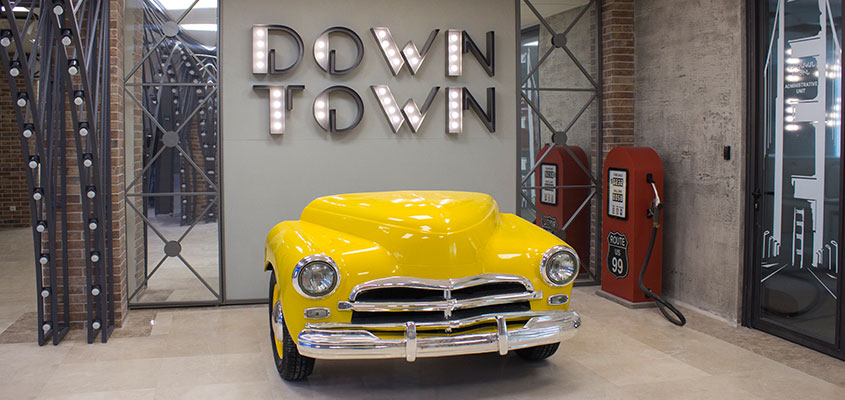 Office entry custom design with a yellow car and illuminated elements