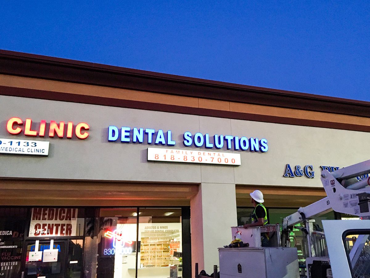 Dental Solutions light box signs displaying business phone number made of acrylic and aluminum