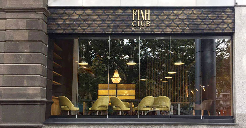 Fish Club restaurant space design with yellow furniture