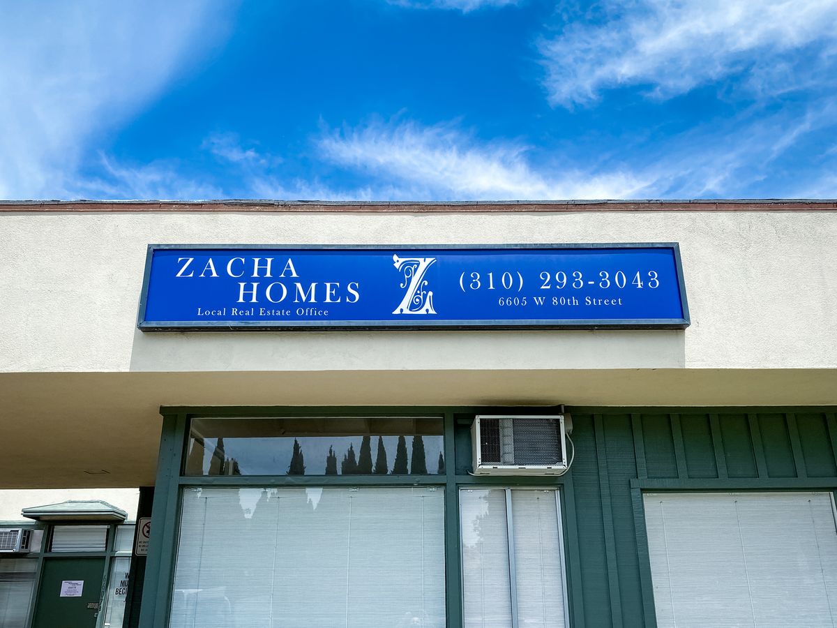 Zacha Homes acrylic light box with the company name and contact details for office branding