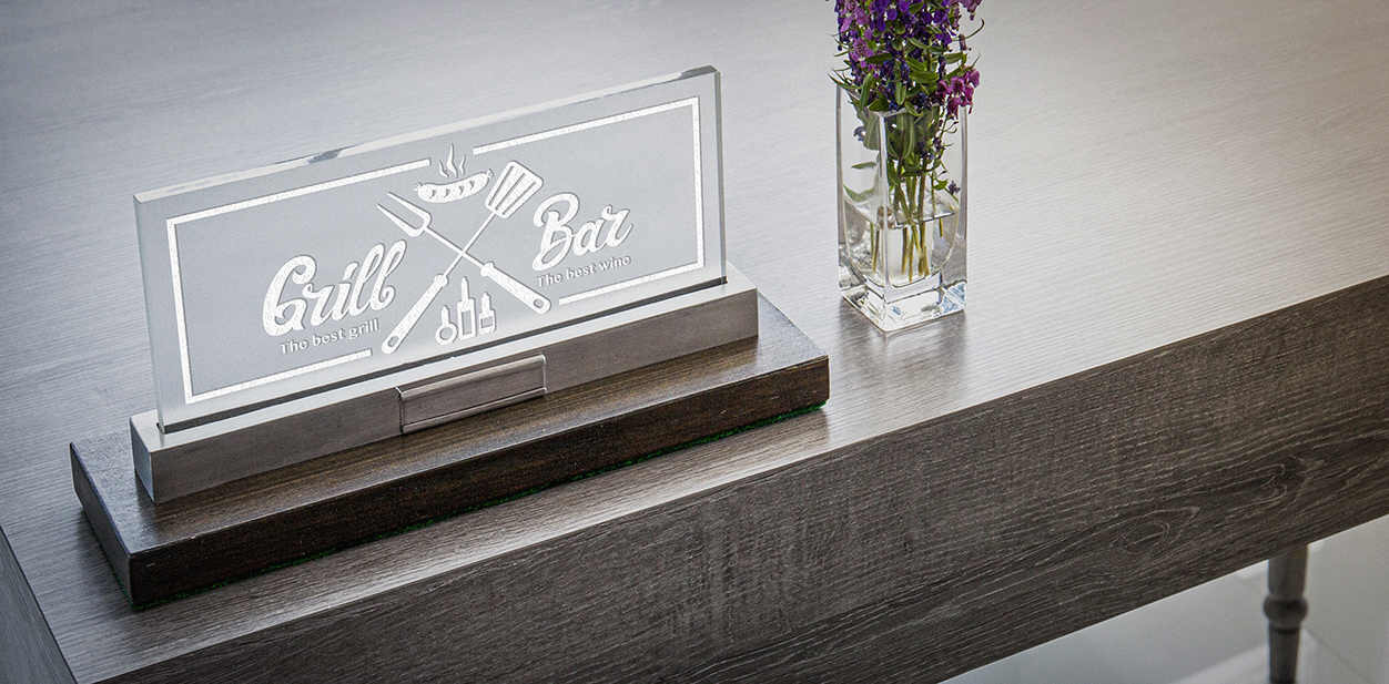 Laser engraving decor idea on acrylic displaying the brand name and logo