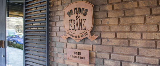 Hans & Franz metallic branded wall plaque