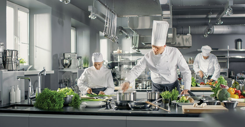 Cooks working in a simple restaurant interior design kitchen space