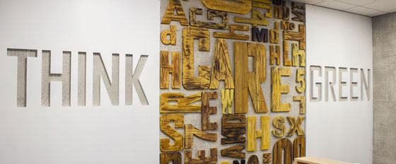 Think Green wooden letters design on a wall