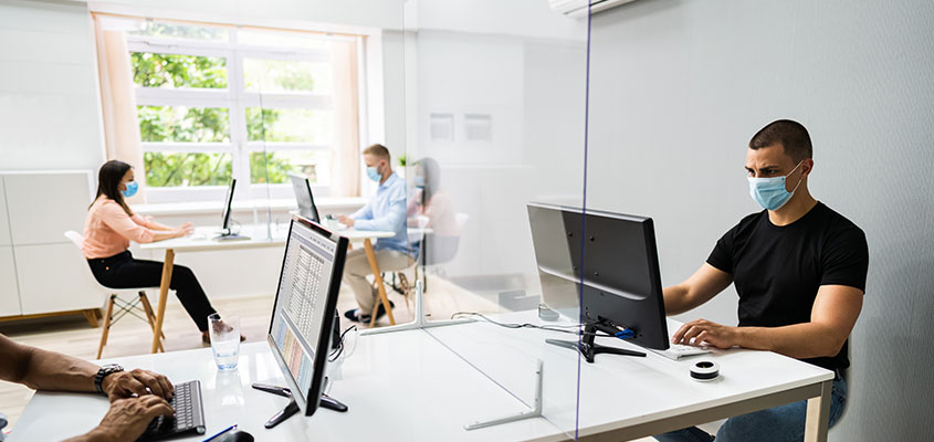 Showcasing how sneeze guard at workspace protects from virus