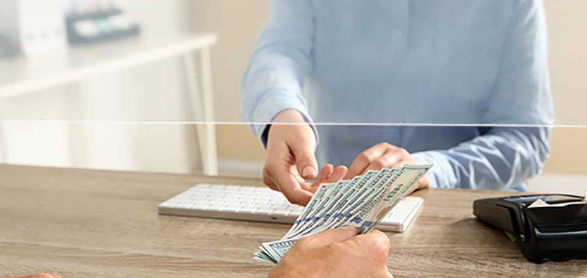 Sneeze shield at cash desk used for protecting against infection