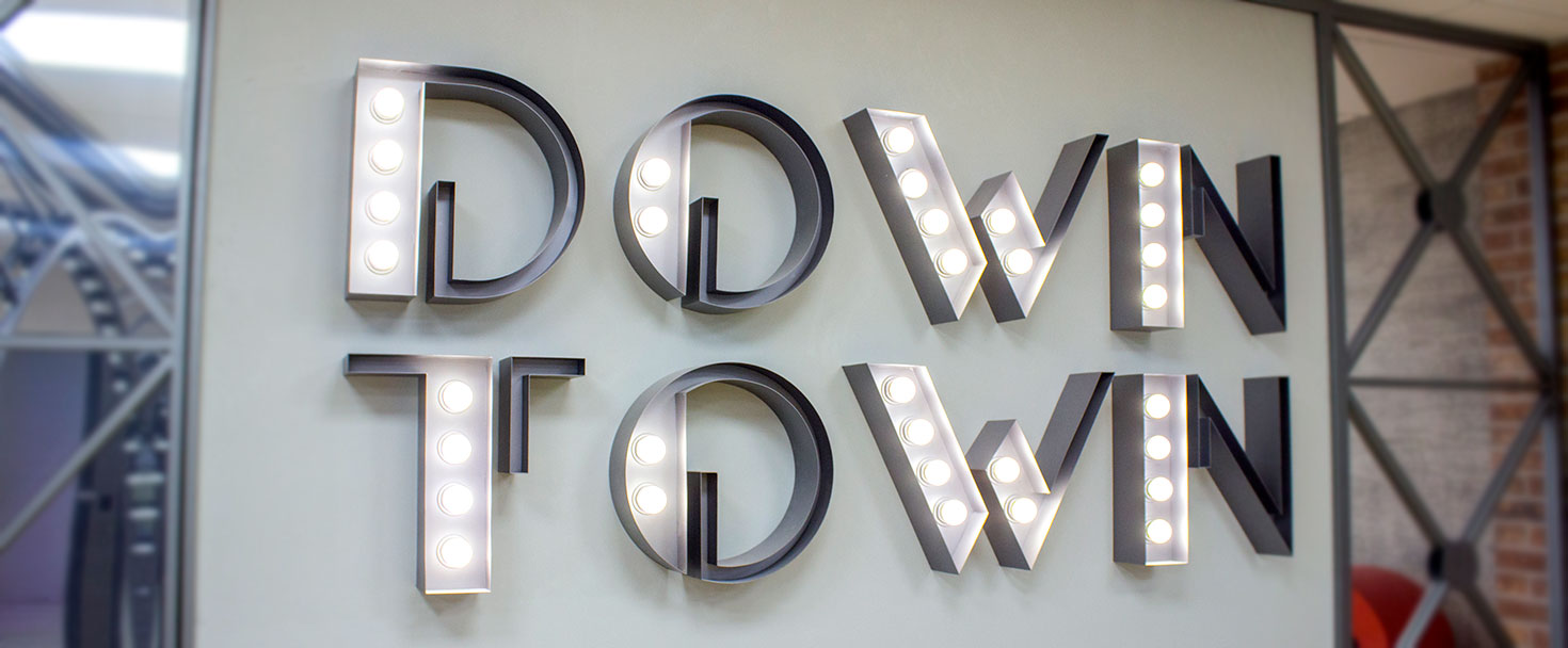 Down Town marquee letters in a light up style spelling out the brand name made of aluminum