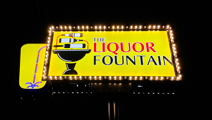 The Liquor Fountain marquee sign displayed on a pole made of aluminum and acrylic for branding
