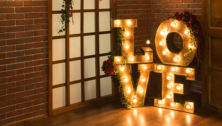 Decorative marquee sign with flowers spelling out the word Love as photoshoot props