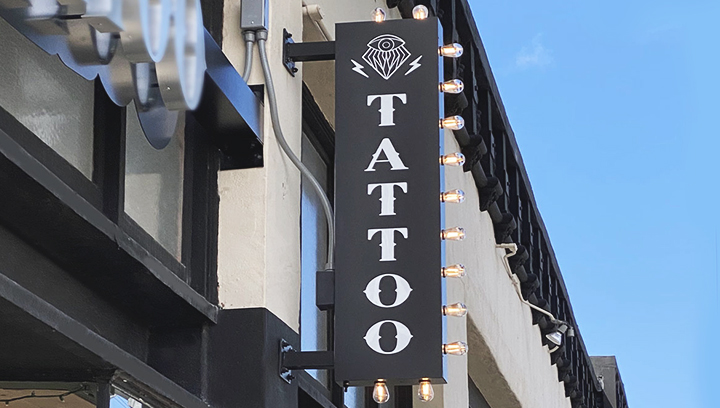 Tattoo store marquee sign with side light bulbs made of aluminum and acrylic for branding