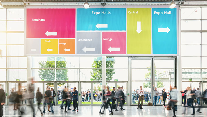 Colorful trade show displays for wayfinding covering the top section of large-scale windows