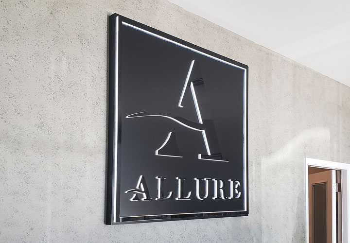 Allure halo lit sign displaying the brand name and logo made of aluminum and acrylic