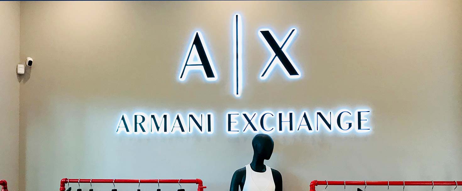 Armani Exchange backlit channel letters showing the brand name and logo in aluminum and acrylic