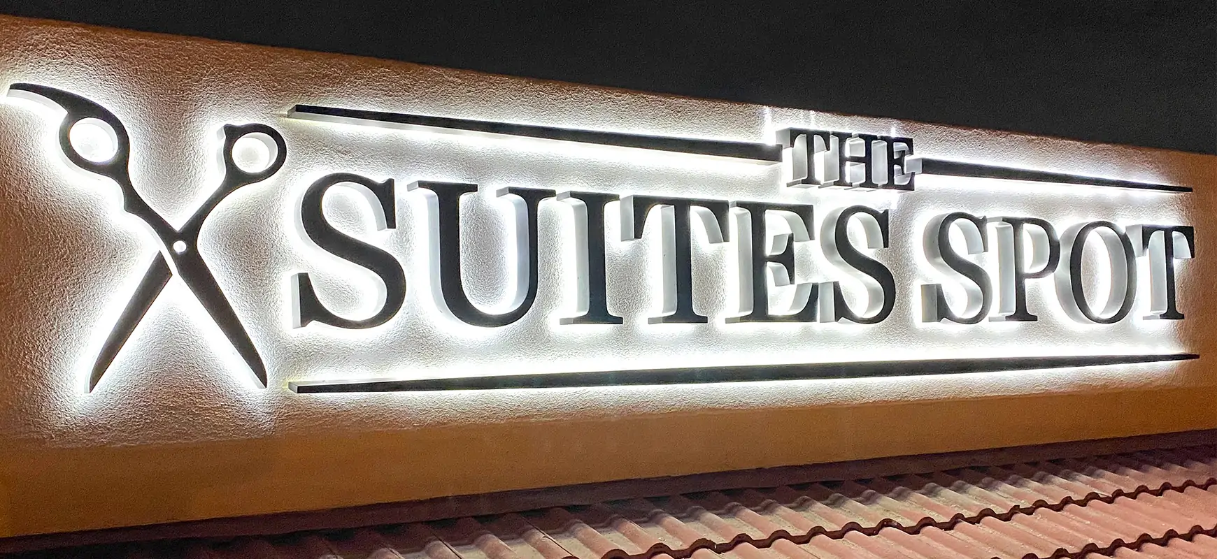 Illuminated backlit channel letters for the Suites Spot, made of aluminum and acrylic