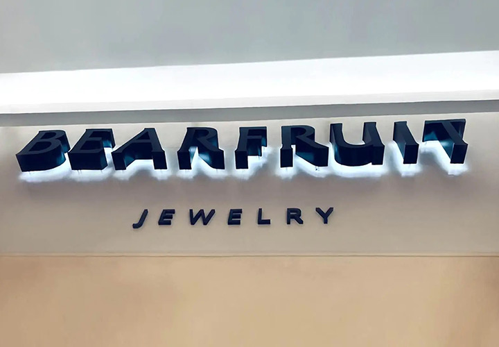 Bearfruit Jewelry backlit channel letters in black made of Lexan and aluminum for branding