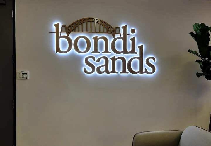 Bondi Sands halo lit sign in a custom style made of Lexan and aluminum for interior branding